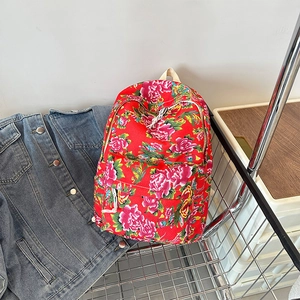Detailed view of large capacity floral backpack with traditional red peony pattern