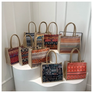 Detailed display of assorted bohemian printed linen tote bags with woven handles