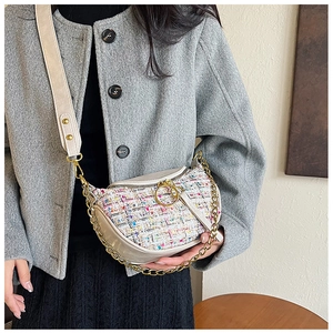 Detail of colorful tweed dumpling bag with gold chain and adjustable fabric strap