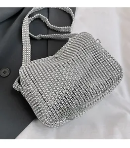 Close-up of shiny silver rhinestone mesh crossbody bag with matching shoulder strap