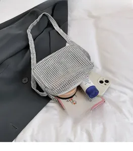 Detail showing ample storage space and silver rhinestone interior of this crossbody bag