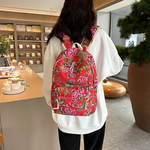Detailed back view of vintage floral backpack with red peony pattern and zippers