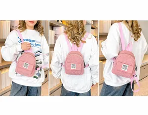 Pink corduroy mini backpack with multi-way straps shown in different wearing styles