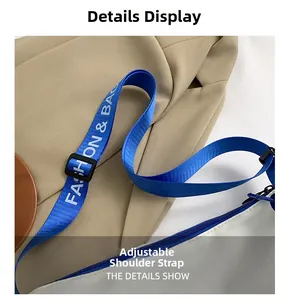 Detail of adjustable blue strap with white text on white casual shoulder bag