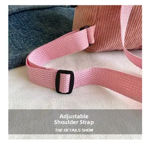 Detail of adjustable pink nylon shoulder strap and buckle on corduroy backpack