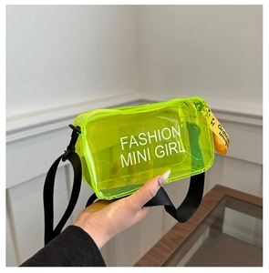 Detail of neon green transparent PVC bag with white letter print and black shoulder strap