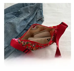 Detail view of red floral shoulder bag interior showing large storage capacity