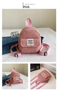 Detail of pink corduroy mini backpack with vertical stripes and fashion label