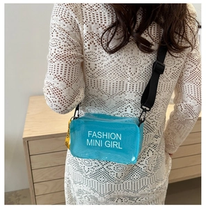 Blue transparent PVC crossbody bag with white fashion mini girl text worn by model