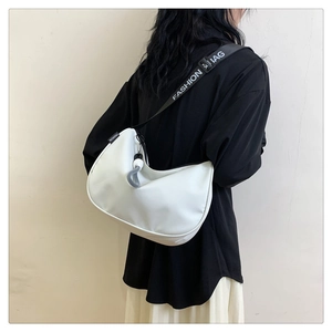 Detail view of white half-moon crossbody bag with contrast fashion slogan strap
