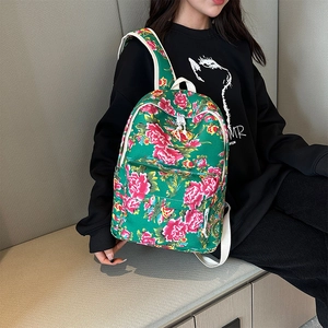 Ethnic style floral backpack with green base and peony patterns for travel use
