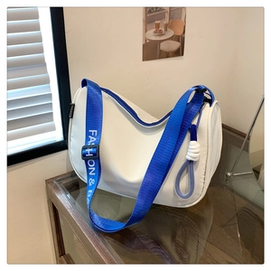 Close-up of white crossbody bag with stylish blue nylon strap and fashion lettering