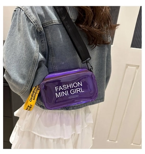 Detail of purple transparent jelly bag with wide black strap and yellow decorative tape