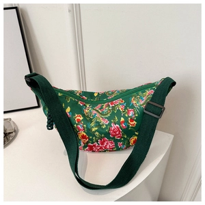 Detail of green floral crossbody bag with peony and phoenix pattern and wide strap