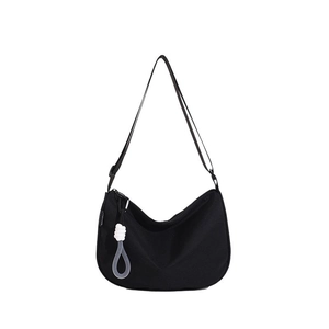 Minimalist black crescent canvas crossbody bag with white cord knot charm decoration
