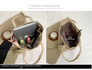Detail view of spacious beige canvas tote bag with internal storage compartments and pouch
