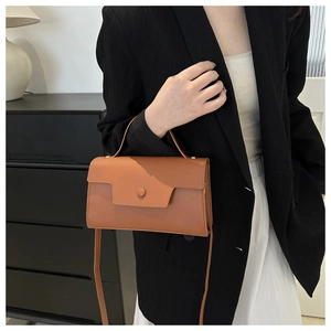 Chic caramel brown leather handbag shown with professional business attire for women
