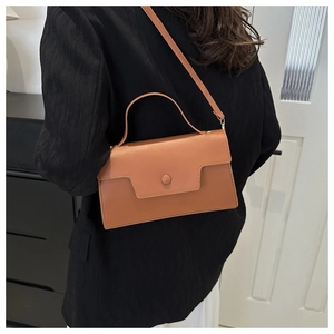 Brown vintage faux leather crossbody bag styled with a professional black blazer outfit