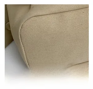 Macro detail showing the precise stitching and durable canvas texture of the beige tote bag