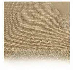 Macro detail of high-quality beige canvas fabric and blue woven label on the tote bag