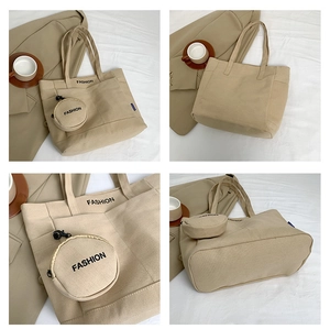 Detailed view of a beige canvas tote bag with a small round pouch and fashion print