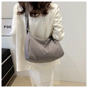 Gray soft padded crossbody bag showing lightweight nylon texture and adjustable strap