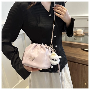 Détail du sac seau lavande à cordon avec chaîne dorée et breloque monstre en peluche