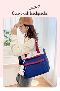 Detail of Korean style tote bag with cute plush duck pendant and circular smile logo