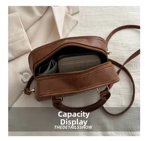 Interior view of brown vintage leather crossbody bag showing spacious storage and wallet