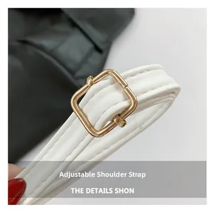 Detail of white faux leather adjustable shoulder strap with golden metal buckle