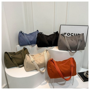 Detail view of large canvas crossbody bags in six colors with adjustable wide straps