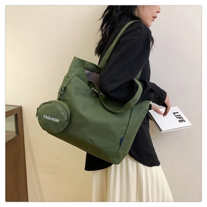 Close-up of olive green canvas tote bag with fashion print and matching round coin purse