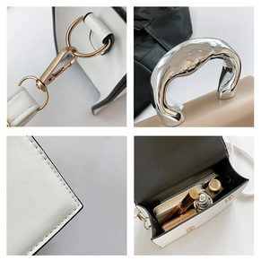 Detail view of contrast color crossbody bag with silver handle and interior storage