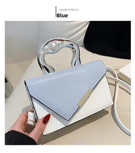 Detail of light blue crossbody bag featuring a unique silver fluid metal handle