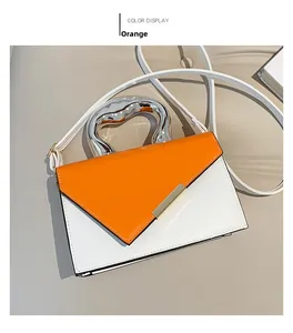 Detail shot of orange and white contrast bag with unique silver metallic handle