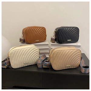Collection of quilted crossbody bags in four colors with decorative wide straps