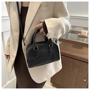 Detail showing the ORN embossed logo and matte leather texture of the black Boston bag