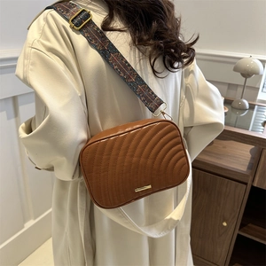 Brown quilted crossbody bag with stylish patterned wide shoulder strap for women