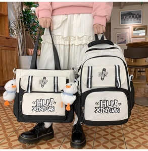 Detail view of the black and white canvas bag set with cute duck charms and artistic print