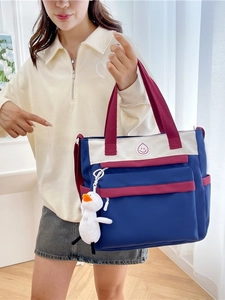 Navy blue and beige student crossbody tote bag with a cute white duck pendant