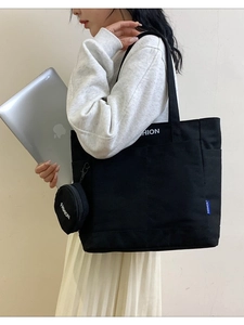 Black canvas tote bag with large capacity and round mini pouch for daily commuting use