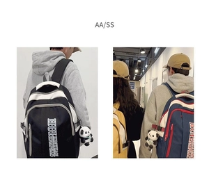 Close-up of contrast nylon backpacks in black-white and navy-red with panda charms