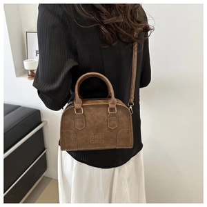 Detail view of a vintage brown leather Boston bag with ORN ORN embossed lettering