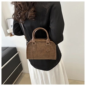 Detailed view of vintage brown leather bag with embossed ORN ORN logo and gold buckles