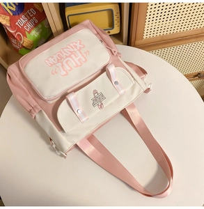 Close-up of pink and white canvas backpack with adjustable straps and front pockets