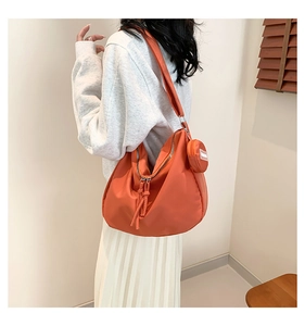 Détail du sac cabas en nylon orange avec son porte-monnaie rond assorti et fermeture éclair