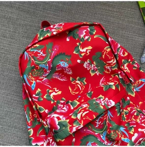 Close-up of traditional Chinese floral pattern backpack with red peony and phoenix design