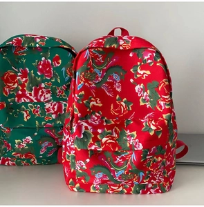 Detail of traditional Chinese floral backpacks with vibrant peony and dragon patterns