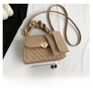 Detailed size comparison of beige quilted tote bag with heart lock and small pouch