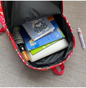 Spacious interior of red floral backpack showing capacity for laptop, books and umbrella